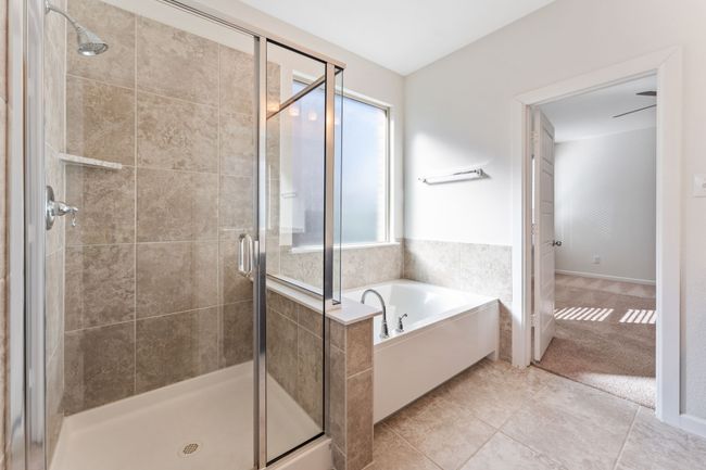 Bathroom featuring a bath, a shower stall, and tile patterned flooring | Image 10