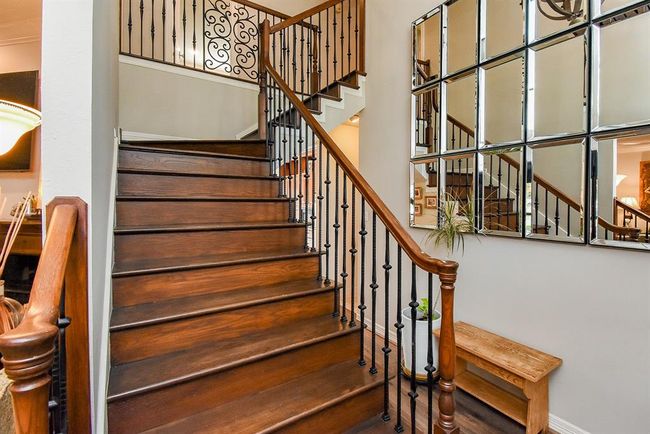 The entry opens to he living room to the left, a hall to the right, and a beutiful staircase. | Image 8