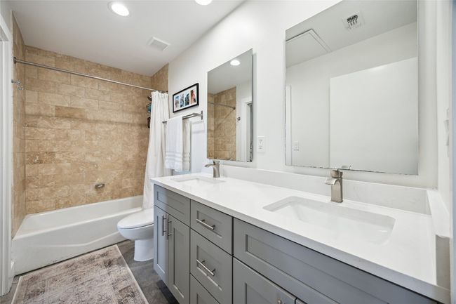 Both bathrooms have been renovated with updated fixtures, cabinets, and countertops | Image 17