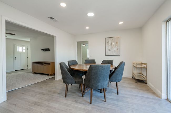 Dining area featuring a ceiling fan, light wood finished floors, and recessed lighting | Image 6
