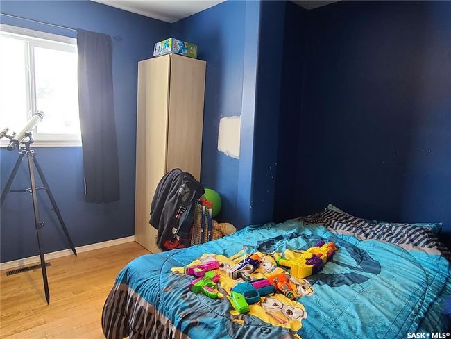 Bedroom with hardwood / wood-style flooring | Image 23
