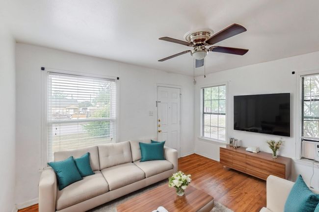 Virtual staged Living room with wood finished floors and ceiling fan | Image 4