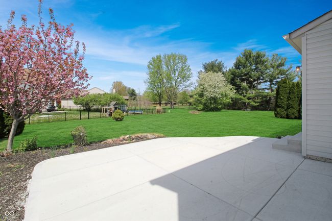 Unwind in your peaceful backyard on this generously sized patio, with plenty of room to create the perfect outdoor living and dining area. | Image 20