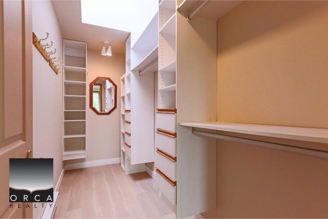Spacious closet featuring light wood finished floors | Image 24