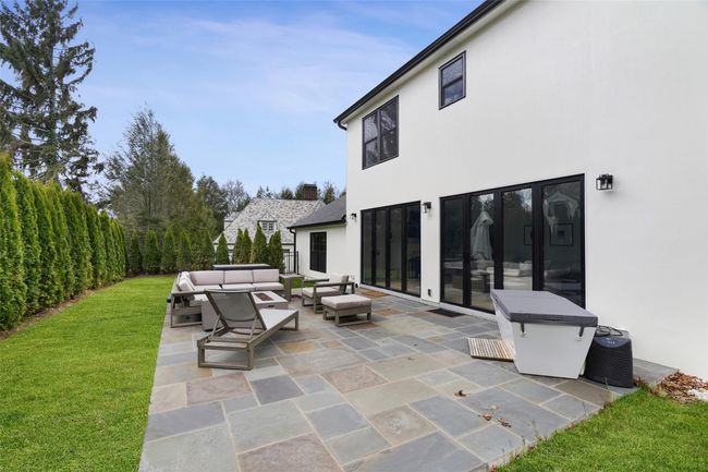 View of patio with an outdoor hangout area and a fenced backyard | Image 34