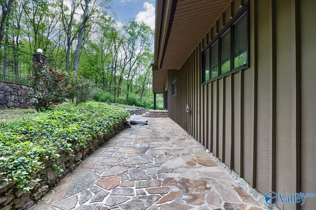 The MCM character is easily seen on the exterior angles and wide eaves that come to a triangle point. Lovely styling and unique opportunity to live in a one of kind home. The BNB wood siding is so timeless! | Image 12