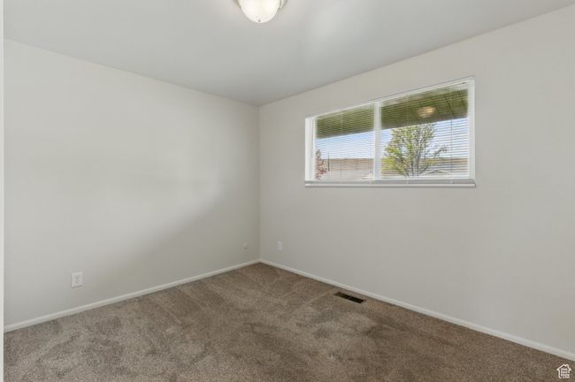 Unfurnished room featuring baseboards, visible vents, and carpet floors | Image 14