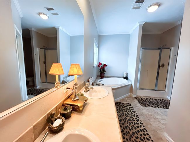 Full bath with a sink, a shower stall, a garden tub, and visible vents | Image 8