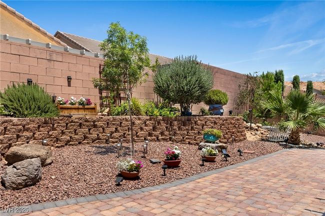 Fenced backyard with a patio area | Image 42