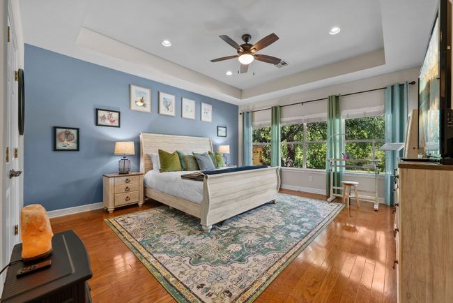 The serene owner's retreat is a peaceful sanctuary with a tray ceiling and a spacious en-suite bath | Image 14