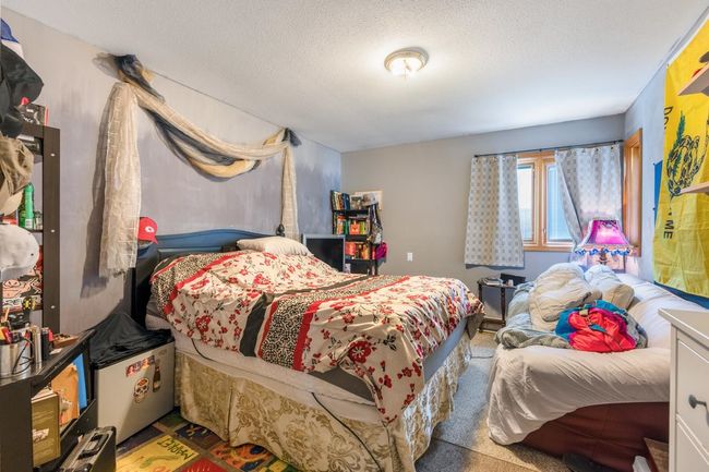 Bedroom with a textured ceiling | Image 31