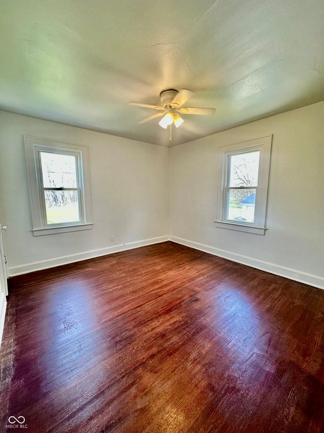 unfurnished room featuring baseboards, ceiling fan, and wood finished floors | Image 37