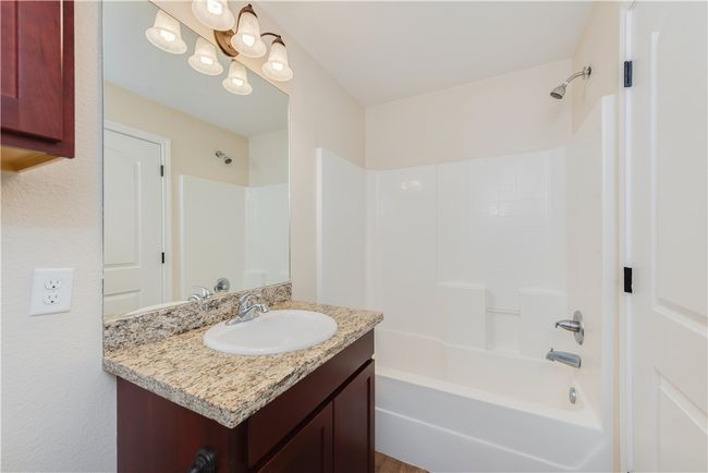 Bathroom featuring vanity and tub / shower combination | Image 9