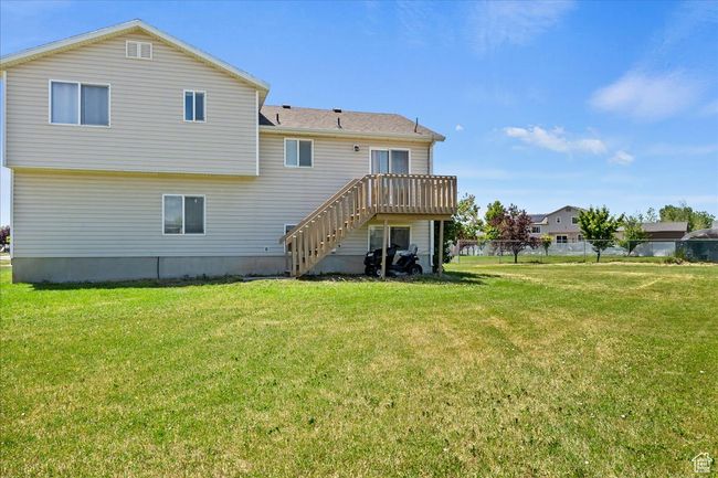 View of green lawn featuring stairs, a deck with mountain view, and a view of countryside | Image 27