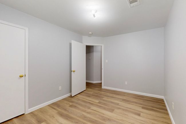 Unfurnished bedroom featuring light wood finished floors, visible vents, and baseboards | Image 19