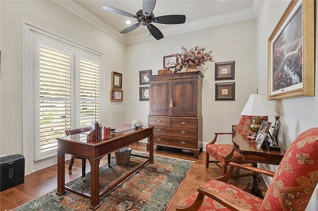 Office space featuring a ceiling fan, wood finished floors, ornamental molding, and recessed lighting | Image 4