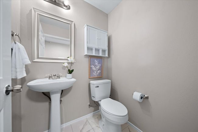 Half bath featuring toilet, baseboards, and marble finish floor | Image 21