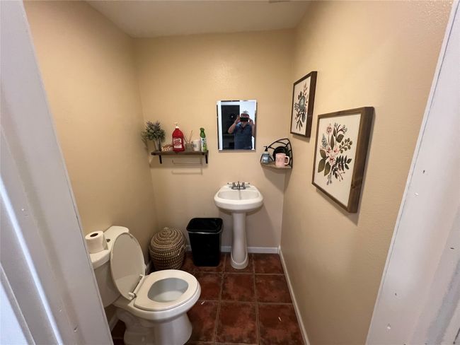 Bathroom with toilet, tile patterned flooring, a sink, and baseboards | Image 26