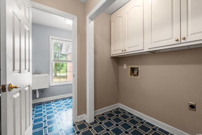Laundry room featuring cabinet space, electric dryer hookup, and washer hookup | Image 20