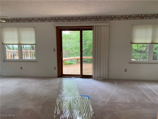 Carpeted empty room featuring healthy amount of natural light and a textured ceiling | Image 27