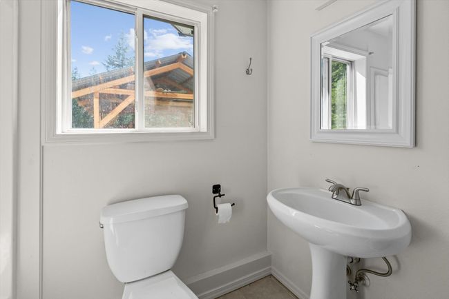 Bathroom with toilet, baseboards, and tile patterned flooring | Image 38