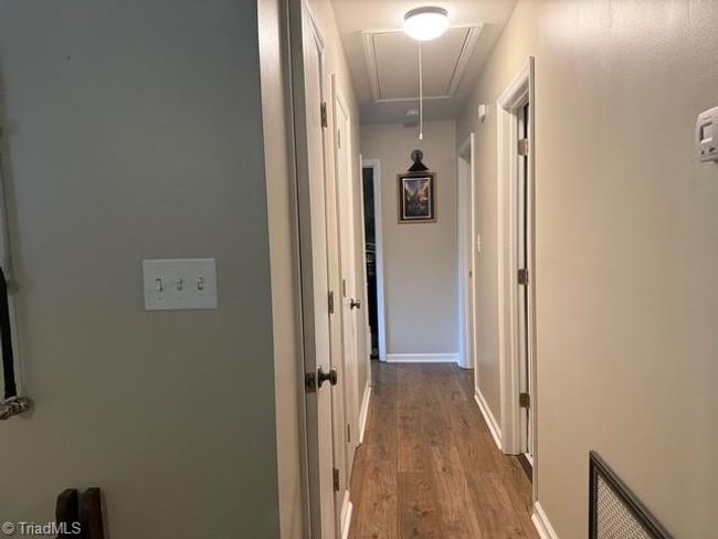 Hallway Leads To Three Bedrooms And Two Baths | Image 11