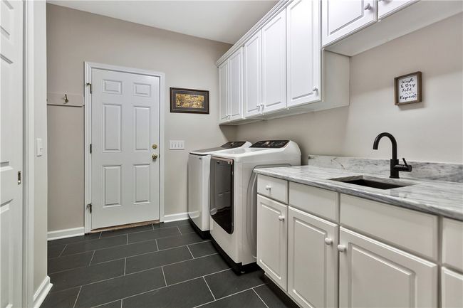 Laundry room with sink, quartz countertops, closet and "drop station". | Image 20
