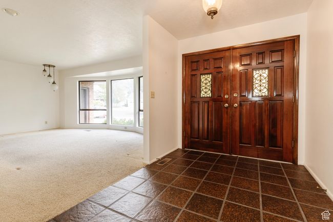 Foyer featuring dark colored carpet and baseboards | Image 4