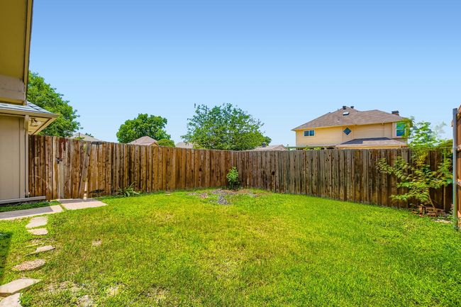 View of fenced backyard | Image 21