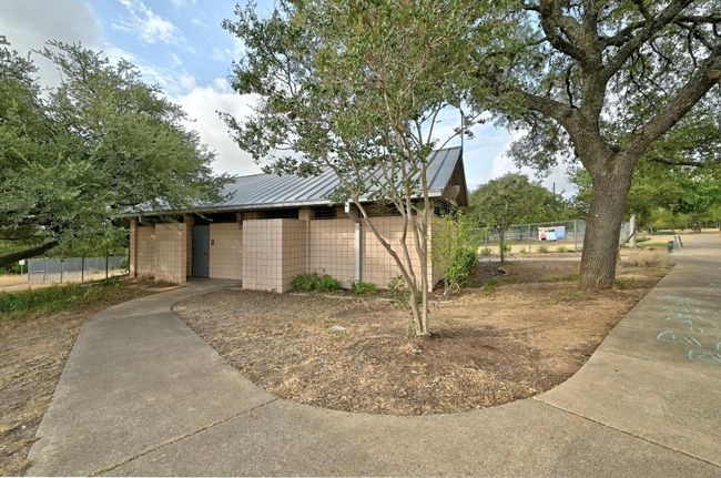 View of home's exterior with an outbuilding, fence, and metal roof | Image 30