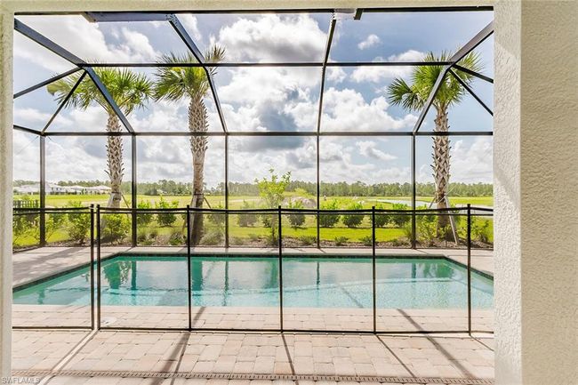 Outdoor pool with a lanai and a patio | Image 28