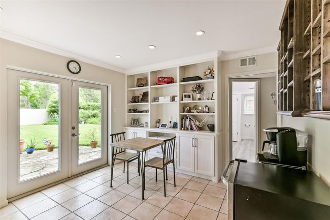 Bright and inviting breakfast nook with built-in shelving, Ideal for relaxed dining and enjoying garden views. | Image 22