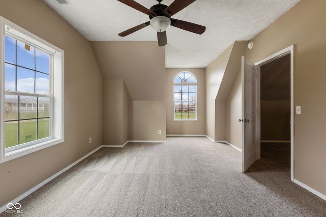 additional living space featuring baseboards, a ceiling fan, vaulted ceiling, and carpet floors | Image 25