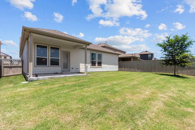 Back of property featuring a fenced backyard, a patio, and a shingled roof | Image 27