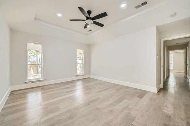 Spare room featuring visible vents, a tray ceiling, and baseboards | Image 17