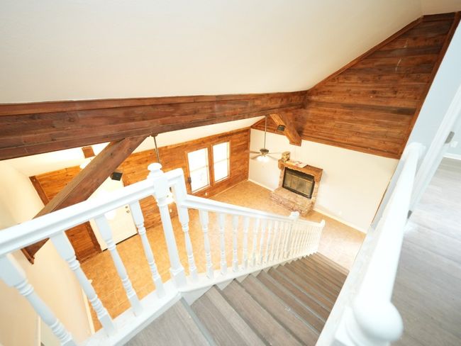 Staircase with vaulted ceiling and ceiling fan | Image 21