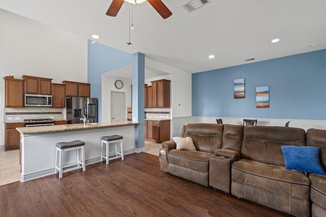 Living area featuring ceiling fan, dark wood-style floors, and recessed lighting | Image 7