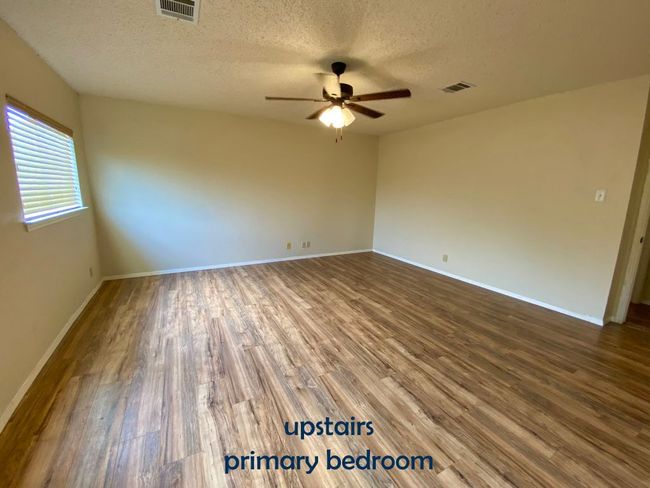 Bedroom with vinyl floors, ceiling fan | Image 18