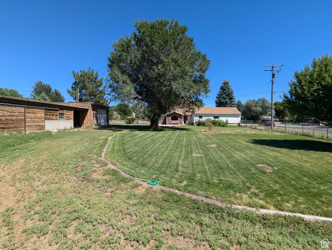 View of yard featuring an outdoor structure and fence | Image 32