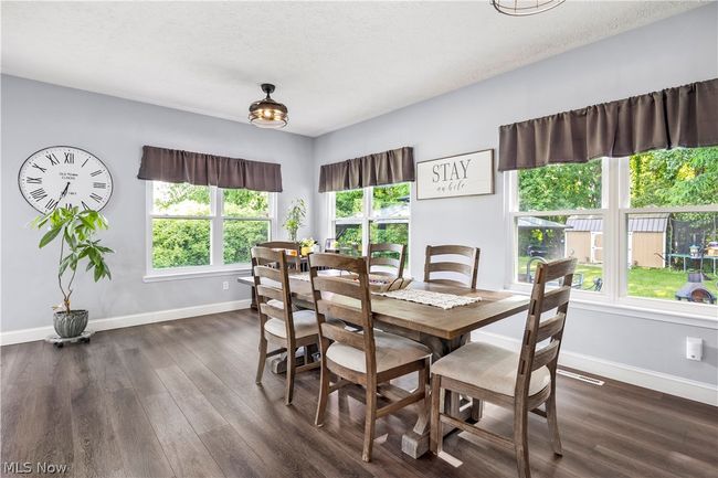 Dining room with dark wood-type flooring | Image 12