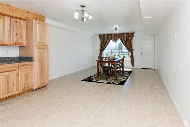 Dining space featuring a chandelier | Image 48