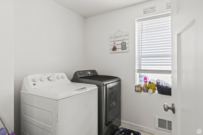 Washroom with washing machine and dryer and baseboards | Image 12