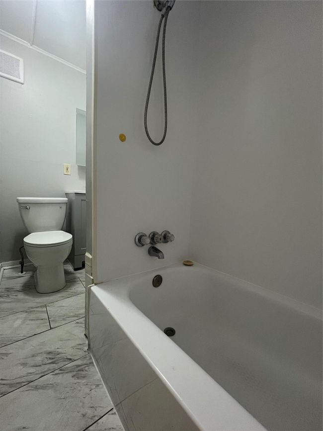 Full bathroom featuring marble finish flooring, toilet, and shower / bathtub combination | Image 8