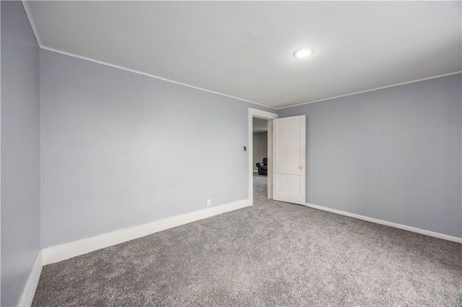 Unfurnished room featuring baseboards and carpet | Image 49