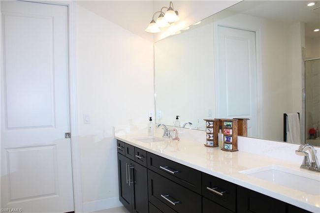 Master Bathroom with an enclosed shower, double vanity, baseboards, and a sink | Image 19