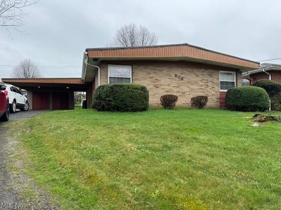 View of home's exterior with a carport and a yard | Image 1