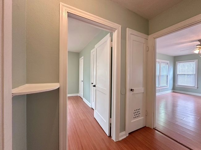Hallway with wood finished floors and baseboards | Image 8