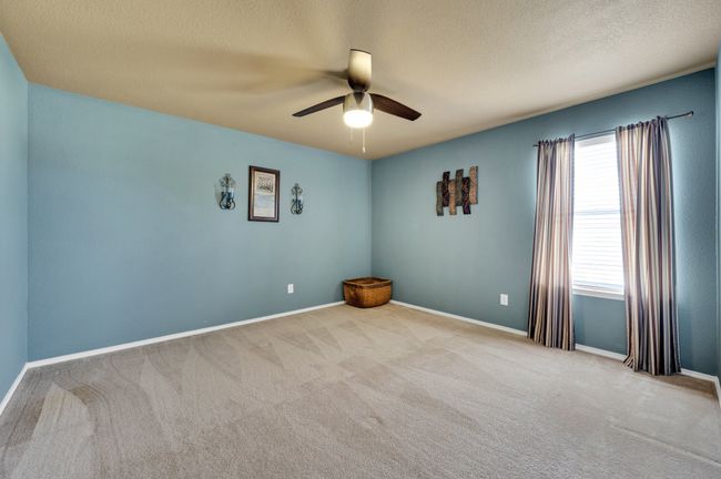 Empty room with ceiling fan, carpet flooring, and a textured ceiling | Image 30