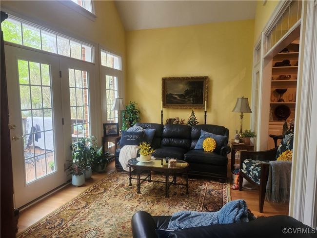 Florida room living area with vaulted ceiling ceiling and wood finished floors | Image 12
