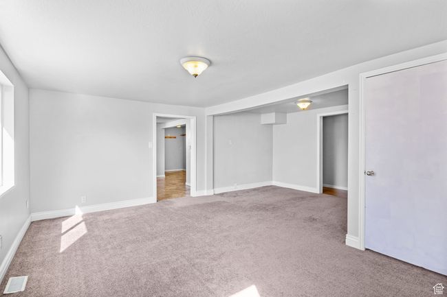 Unfurnished bedroom featuring carpet floors, baseboards, and visible vents | Image 31